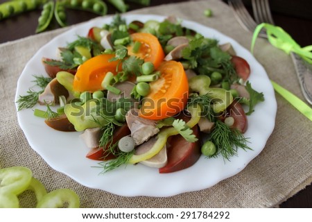 salad with tomatoes, lamb tongues under a dressing of balsamic vinegar