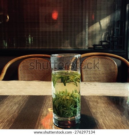 A green tea in a glass on the table of a tea house