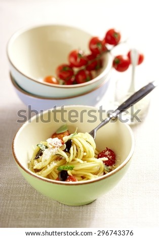Small Portion of Spaghetti Pasta with Cherry Tomatoes in Bowl on Fabric Tablecloth