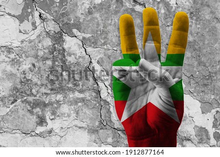 The 3-finger raised as a protest sign with a painted flag of Myanmar. Concept of the people protesting violence, injustice, and dictatorship. Fight for democracy. 3D Illustration, 3D rendering Photo stock © 