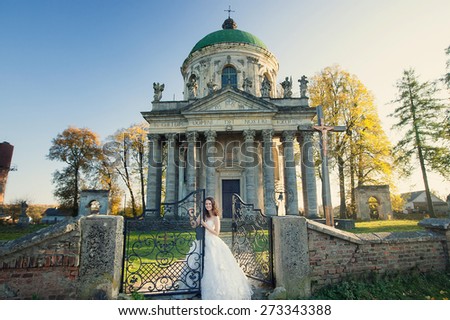 happy bride near the magnificent architecture