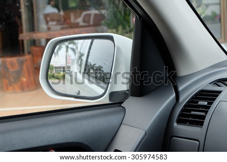 Exterior side mirrors of cars viewed from inside the car.