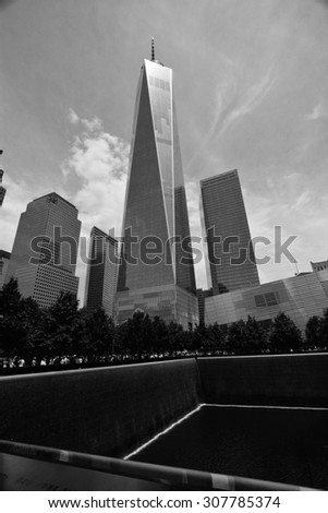 Freedom Tower New York/ One World Trade Center/ New York, USA - June 11, 2015: Freedom Tower, New York City, One World Trade Center with 9-11 memorial park in foreground on sunny day