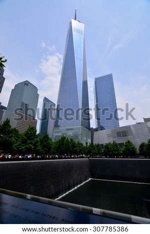 Freedom Tower New York/ One World Trade Center/ New York, USA - June 11, 2015: Freedom Tower, New York City, One World Trade Center with 9-11 memorial park in foreground on sunny day