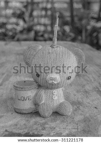 Black and white,The doll have holder for pen and pencil on the table.