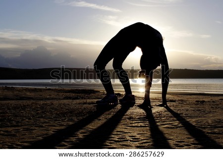 silhouette of a girl in the pose of rhythmic gymnastics
