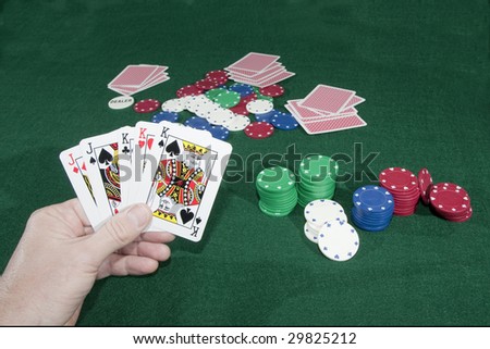 Winning poker hand over green poker table with chips