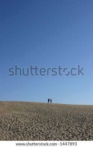 couple flying kite on sand dunes - Outer Banks - NC