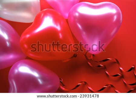 Red and Pink Heart shaped Balloons on a red background