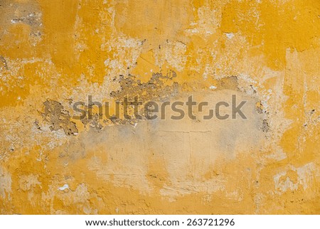Old wall painted with yellow paint