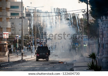 BETHLEHEM, PALESTINIAN TERRITORY - NOVEMBER 20: An Israeli military jeep launches tear gas in the West Bank town of Bethlehem during protests against Israel\'s attacks on Gaza, November 20, 2012.
