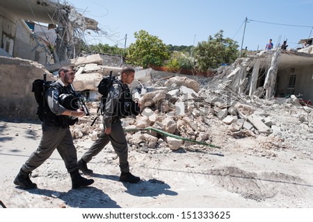 JERUSALEM - APRIL 24: Israeli border police guard the demolition of the Jaradat family home in the Al Tur neighborhood of East Jerusalem, April 24, 2013.