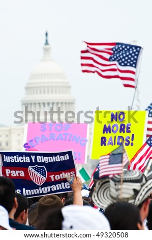 WASHINGTON, DC - MARCH 21: The U.S. Capitol building in the distance, some 200,000 immigrants' rights activists flood the National Mall to demand comprehensive immigration reform on March 21, 2010 in Washington DC.