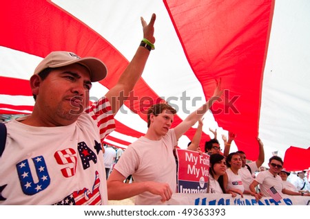 WASHINGTON, DC - MARCH 21: A giant American flag is carried among some 200,000 immigrants\' rights activists flood the National Mall on March 21, 2010 in Washington DC.