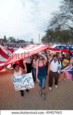 WASHINGTON, DC - MARCH 21: A giant American flag is carried among some 200,000 immigrants\' rights activists flood the National Mall  on March 21, 2010 in Washington, DC.