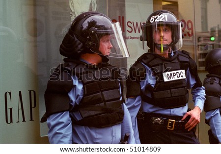 WASHINGTON, DC - SEPT 27: Police in full riot gear and batons guard Gap stores during anti-sweatshop protests in Washington, DC on Sept. 27, 2002.