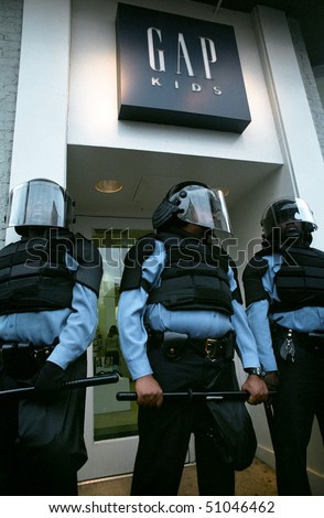 WASHINGTON, DC - SEPT 27: Police in full riot gear and batons guard Gap stores during anti-sweatshop protests on Sept. 27, 2002 in Washington, DC .