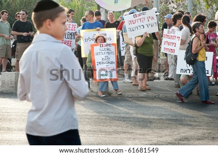 EAST JERUSALEM - SEPTEMBER 24: A Jewish boy watches as activists protest Israeli settlements in the East Jerusalem neighborhood of Sheikh Jarrah on Sept. 24, 2010 in East Jerusalem.