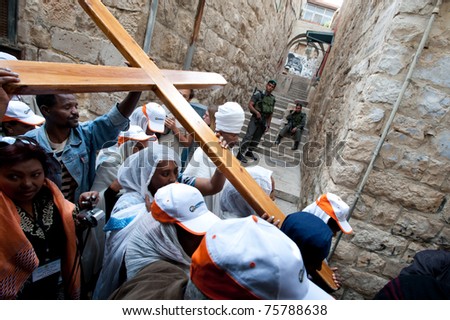 JERUSALEM - APRIL 22: Ethiopian Christian pilgrims commemorate the path Jesus carried his cross on the day of his crucifixion along the Via Dolorosa in Jerusalem on Good Friday, April 22, 2011.