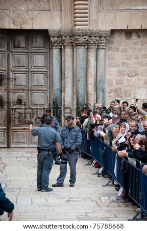 JERUSALEM - APRIL 22: Israeli police control crowds waiting to enter the Church of the Holy Sepulcher in Jerusalem on Good Friday, April 22, 2011.