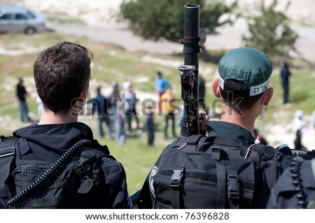 JERUSALEM - APRIL 22: Israeli riot police wield tear gas guns during clashes with Palestinian youth in the East Jerusalem neighborhood of Al-Isawiyya on April 22, 2011.