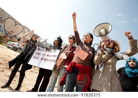 KALANDIA, OCCUPIED PALESTINIAN TERRITORIES - MARCH 8: Palestinian women, Israeli, and international solidarity activsits march to protest the Israeli occupation on International Women\'s Day 2012.