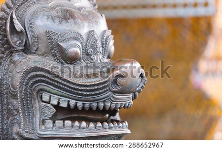 BANGKOK, THAILAND - 19 MARCH 2013: Face of bronze lion statue. Wat Pho Temple in Bangkok. Wat Pho is one of the oldest temples in Bangkok and is home to the famous Reclining Buddha.