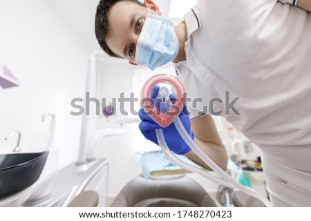 close up of male doctor doing sedation. Dentist concept. Medical concept. getting narcosis before the procedure.General anesthesia. oxygenation.anesthetic mask. bottom view of doctor giving oxygen. Stock foto © 