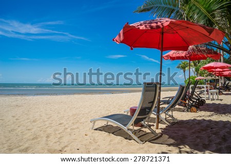 turquoise sea, deckchairs, white sand and palms, sun