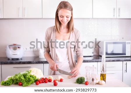 Young Woman Cooking in the kitchen.  Dieting vegetarian concept. Healthy Lifestyle. Cooking At Home. Prepare Food