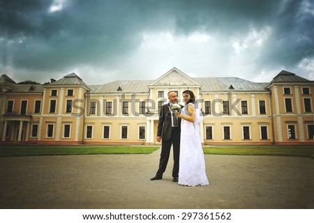 Wedding  adult couple in the courtyard of castle  before the storm