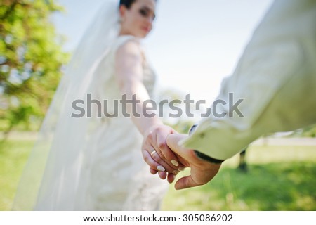 Holding hands of married couple