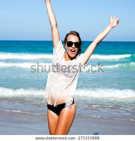 smiling summer girl,with blond hair and swimsuit,laughing and smiling , summer mood , cheerful girl on the sea, red lips , natural makeup, summer black sunglasses