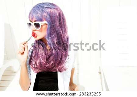 Pretty closeup portrait of sensual fashionable woman in glasses with summer party clothes,woman with glowing skin,party concept.Eating sweets on the beach,summer bikini store,posing  on white.