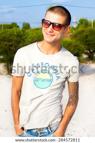 Handsome young man posing on the beach.Travel concept,lifestyle portrait of man working abroad and looking forward.outdoor portrait of man on the beach,attractive,emotional person.traveling man,hiker