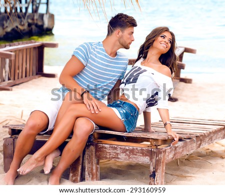 Summer stylish fashion sensual portrait of a happy,sexy couple in love.Gorgeous,young,beautiful lovers,on vacation in a tropical country.Kissing and hugs.couple in love.tan couple holding hands,trendy