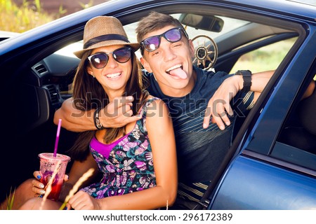 Outdoor portrait of laughing smiley couple,shows funny faces together,couple in sunglasses,funny face,funky,fancy,emotional people,hikers,funny couple,romantic date,road trip,friends having fun,trip