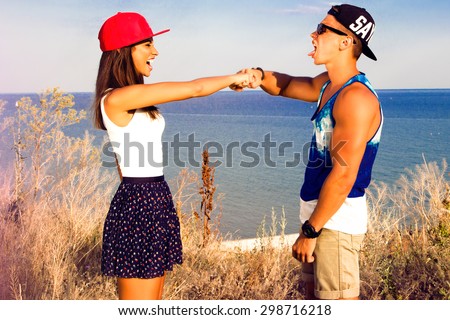 Lifestyle portrait of Happy friends give five,friendly hug,shake hands,punched,enjoy their summer vacation on amazing beach,hipster friends,lifestyle portrait of stylish hipster couple in love.swag