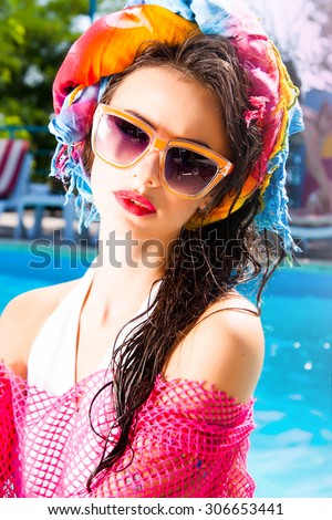 Outdoor fashion portrait of glamour lady enjoying her vacation on luxury villa over the pool,wet hair,stylish sunglasses,bikini.perfect nail polish.Summer accessory,sunglasses fashion,flash tattoo
