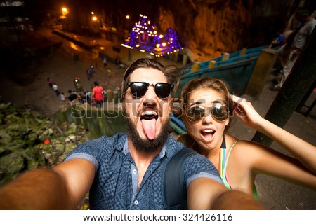 Outdoor portrait of beautiful traveling couple,hiker couple,hipster outfit,make selfie of their Asia trip,happy laughing couple,couple in sunglasses,emotional man and tongue girl,crazy selfie,hikers