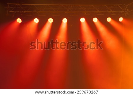 Stage lights on concert. Lighting equipment with multi-colored beams.