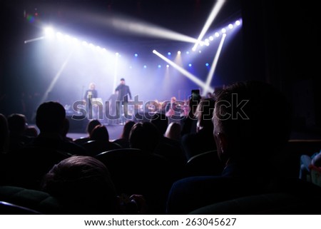 The audience at a concert on background of scene.