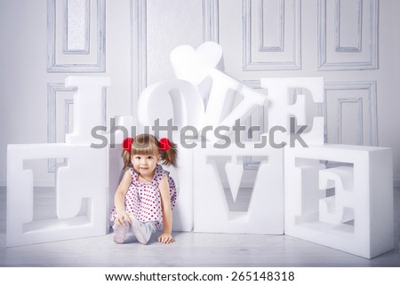 Little girl with big letters \