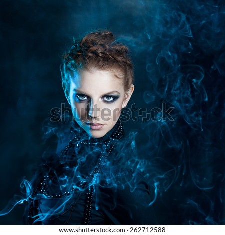 Mysterious portrait  beautiful females, red-haired girl in the smoke
