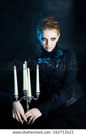 Mysterious portrait of beautiful females,  girl holds a candle