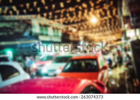 people in bokeh, street of night Bangkok, taxi and tuk-tuk