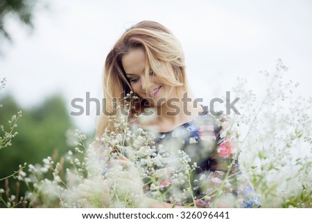 Beauty Girl Outdoors enjoying nature, blond girl in dress  on a meadow