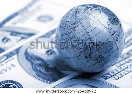 a globe and cash closeup