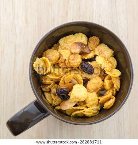 Mix corn flake cereal in a cup of brown.