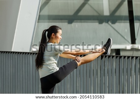 Similar – Image, Stock Photo Positive Asian sportswoman leaning on barbell in modern gym and looking at camera